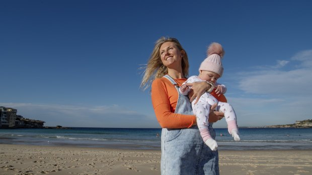 Annie Slattery, who immigrated from Ireland in 2009, with her baby daughter Romy at Bondi. 