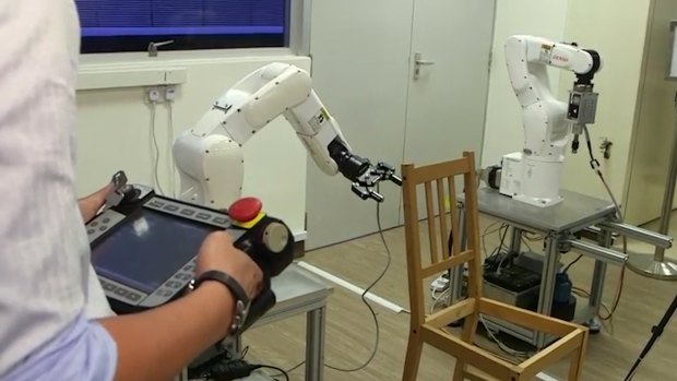 Researchers at Singapore's Nanyang Technological University program the robot.