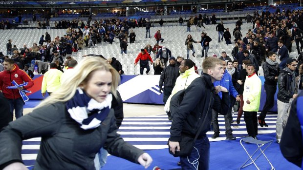 Spectators invade the pitch after the match.