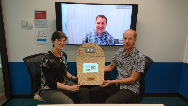 Professor Janet Wiles, the robot Opie, Google's Daan Van Esch (on screen) and Ben Foley at Google HQ in Sydney.