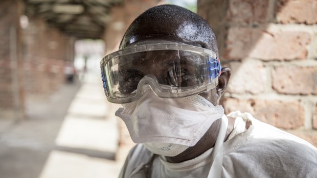 A health worker wears protective clothing outside an isolation ward to diagnose and treat suspected Ebola patients, at Bikoro Hospital in Bikoro, the rural area where the Ebola outbreak was announced last week, in Congo. 