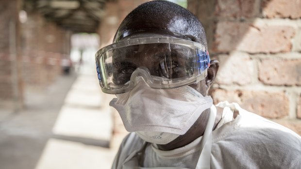 A health worker wears protective clothing outside an isolation ward to diagnose and treat suspected Ebola patients, at Bikoro Hospital in Bikoro, the rural area where the Ebola outbreak was announced last week, in Congo. 