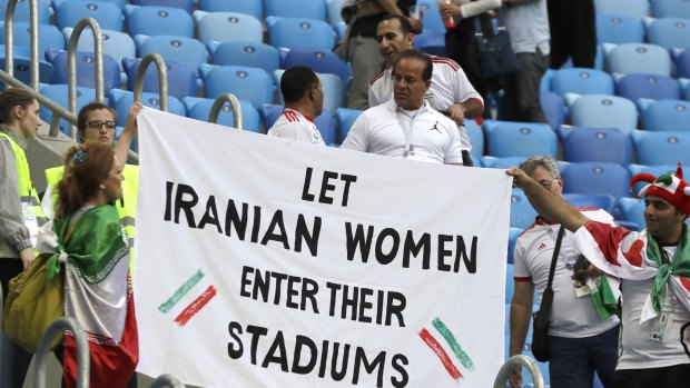 Another banner calls for Iran to allow female supporters to attend local matches.