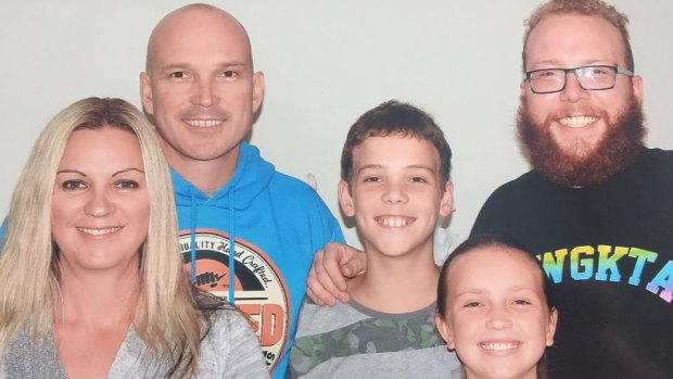 Scott Blanchard (in the blue jumper) with his three kids and wife Justine.