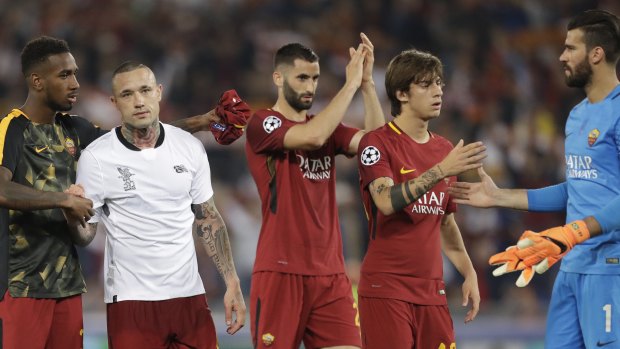 Falling short: Roma players applaud the fans after the match.