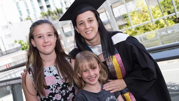Juliana and Kaitlyn Guljas with their mum Jill on her graduation day.