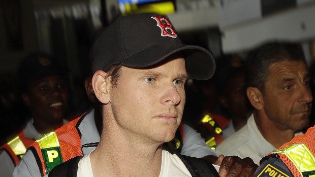 Steve Smith was escorted by police officers on departure in Johannesburg. 