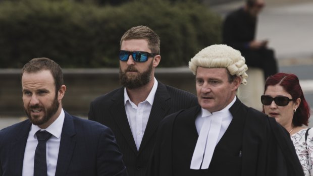 Alister Spong (second from left), joined by his wife, solicitor Jacob Robertson (left) and barrister Steven Whybrow (right)  arrives at the ACT Supreme Court for the trial over his friend's death at Summernats.