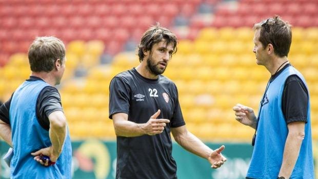 Roar star Thomas ?Broich talks to coach Mike Mulvey ahead of the team's opening A-League match at Suncorp Stadium.