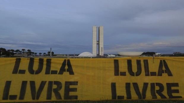 A banner that says in Portuguese "Free Lula" is seen near the Congress and Senate buildings in Brasilia.