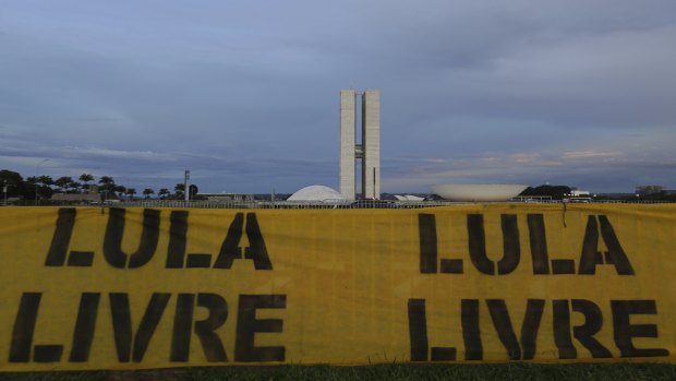 A banner that says in Portuguese "Free Lula" is seen near the Congress and Senate buildings in Brasilia.