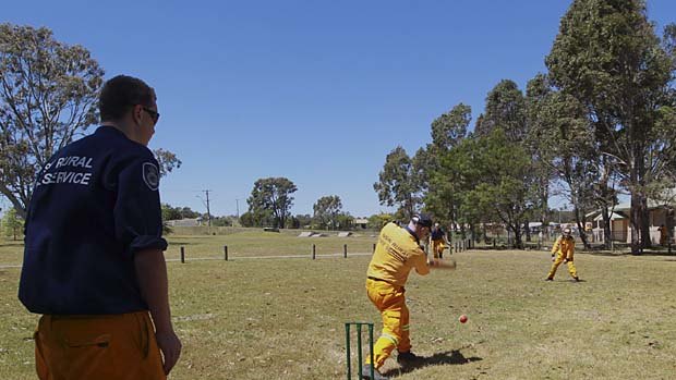 Firefighters enjoy a game of cricket whilst waiting for the fires to worsen.