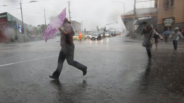 Wild wind and rain hits the Melbourne CBD on Saturday.