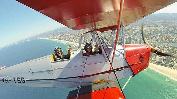 Pilot Alex James "Jim" Rae, 26, flies a Tiger Moth over the Gold Coast.