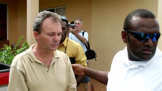 Conman Peter Foster is led back into custody after being captured in Vanuatu. Picture: Xavier La Canna