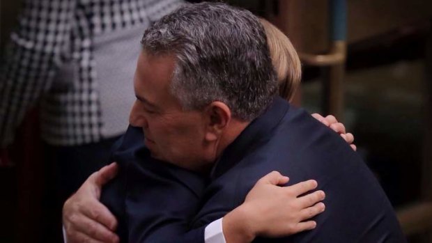 Treasurer Joe Hockey is hugged by his 8 year old son Xavier after he delivered his first budget. Photo: Andrew Meares