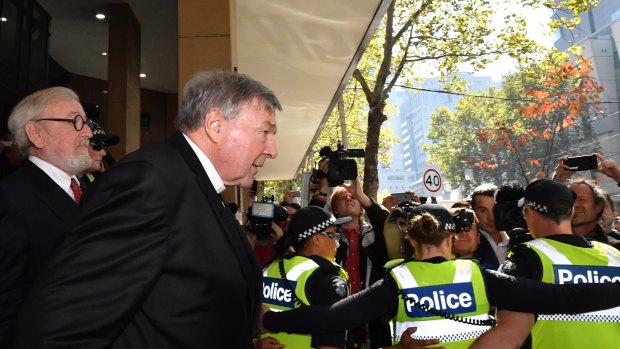 Cardinal Pell leaves the court with lawyer Robert Richter, QC.