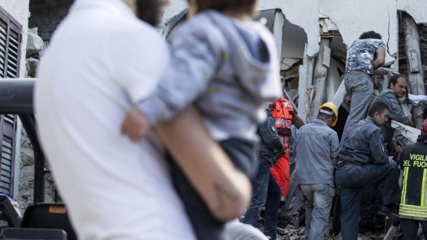 Firefighters search amid rubble following an earthquake in Accumoli, central Italy.