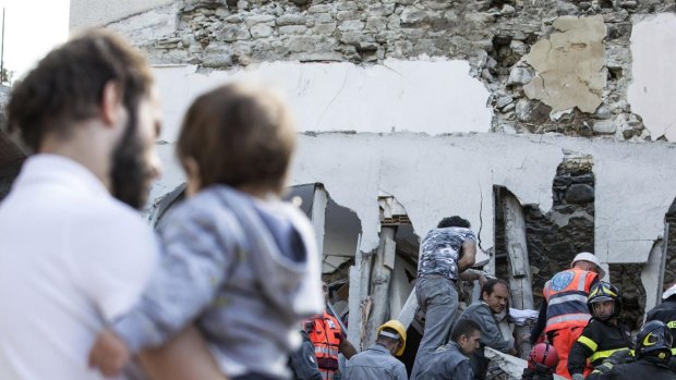 Firefighters search amid rubble following an earthquake in Accumoli, central Italy.