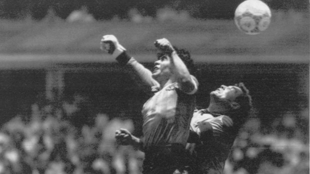 Diego Maradona (left) beats England goalkeeper Peter Shilton to a high ball and scores the "Hand of God" goal off his left hand.