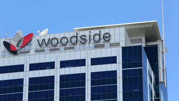 Woodside Petroleum's profit has almost halved on write-downs. 
