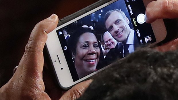 Macron stops to take a selfie with Texas Democrat Sheila Jackson Lee, after addressing the US Congress.