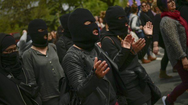 Masked women shout slogans during a protest against sexual abuse in Pamplona, northern Spain.