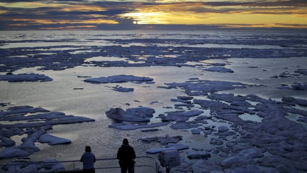 Diminishing Arctic ice: researchers look out from the Finnish icebreaker MSV Nordica as the sun sets over sea ice in the Victoria Strait along the Northwest Passage in the Canadian Arctic Archipelago in July 2017.