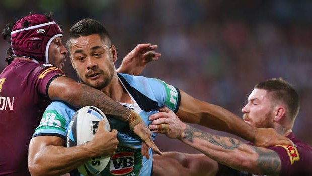 Blues fullback Jarryd Hayne breaks through the defence of Johnathan Thurston and Chris McQueen.