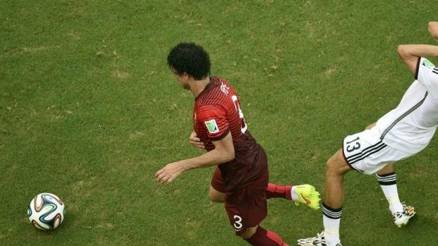 Germany's Thomas Mueller reacts after being hit by Portugal's Pepe.