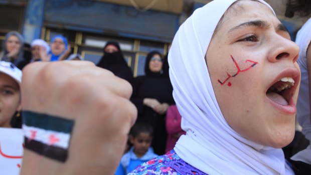 A girl with "Aleppo" written on her face shouts slogans during an anti-government demonstration in Bennish, on the outskirts of Idlib province, in August 2012.