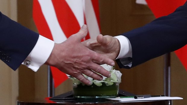 Donald Trump, left, and Vladimir Putin shake hands at the beginning of a meeting at the Presidential Palace in Helsinki, Finland, on Monday.