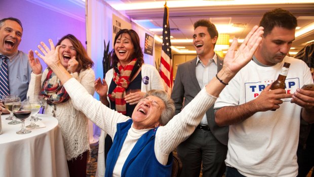Not everyone rejoiced at Thanksgiving. Republican Party supporter Georgia Touloumes, 86, of Venetia, Pennsylvania, shouts with joy surrounded by her family as more states are announced for Republican presidential candidate Donald Trump.