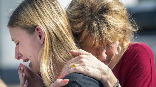Student Dakota Shrader mourns with her mother.
