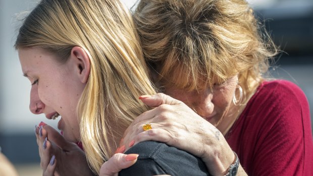 Student Dakota Shrader mourns with her mother.