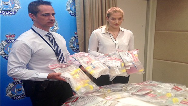 Police officers with some of the seized drugs.