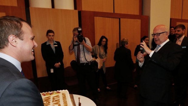 Attorney-General Senator George Brandis takes a photo of Human Rights Commissioner Tim Wilson.