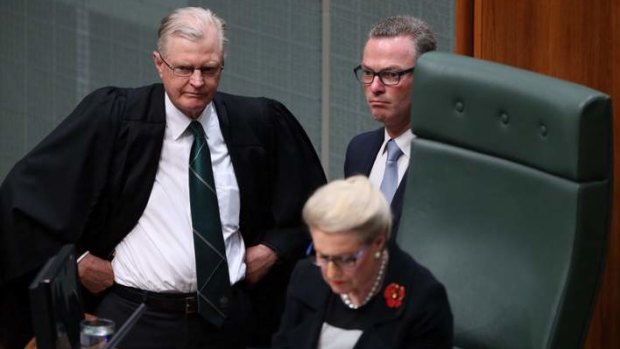 The Clerk of the House and Christopher Pyne stand behind the Speaker Bronwyn Bishop as the Opposition move a motion to refer her to the Privileges Committee. Photo: Andrew Meares