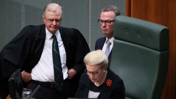 The Clerk of the House and Christopher Pyne stand behind the Speaker Bronwyn Bishop as the Opposition move a motion to refer her to the Privileges Committee. Photo: Andrew Meares