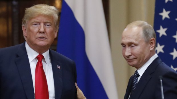 U.S. President Donald Trump, left, and Russian President Vladimir Putin leave after a press conference after their meeting at the Presidential Palace in Helsinki, Finland.