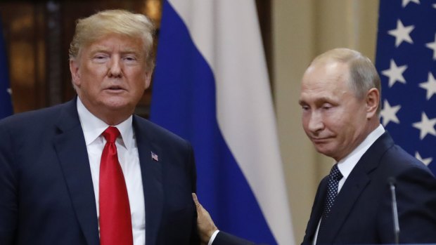 U.S. President Donald Trump, left, and Russian President Vladimir Putin leave after a press conference after their meeting at the Presidential Palace in Helsinki, Finland.