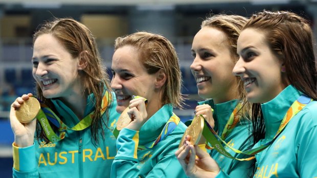 Australia's Cate Campbell, Bronte Campbell, Emma McKeon and Brittany Elmslie, from left, hold their gold medals after winning the women's 4x100-meter freestyle final setting a new world record. 