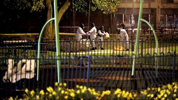 Investigators in protective suits work near the scene of the poisoning in Salisbury, England.