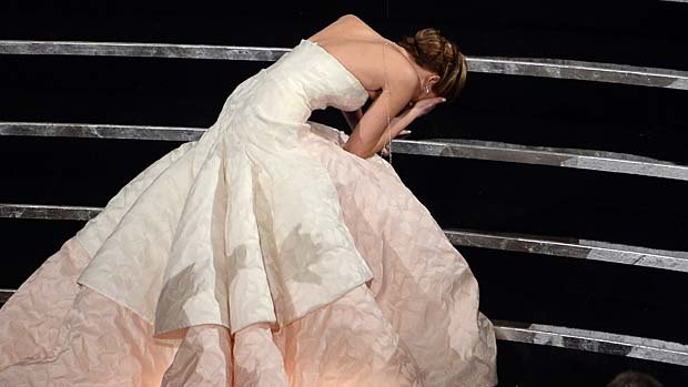 Jennifer Lawrence trips on her way to the stage.