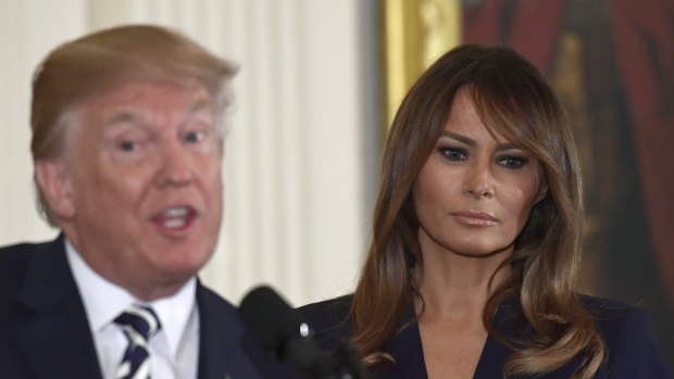 US President Donald Trump speaks while first lady Melania Trump listens earlier this month. 
