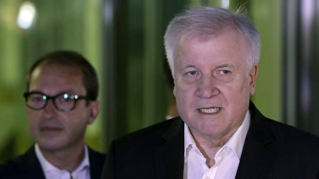 German Interior Minister and chairman of the German Christian Social Union (CDU), Horst Seehofer, right, addresses the media after the meeting.
