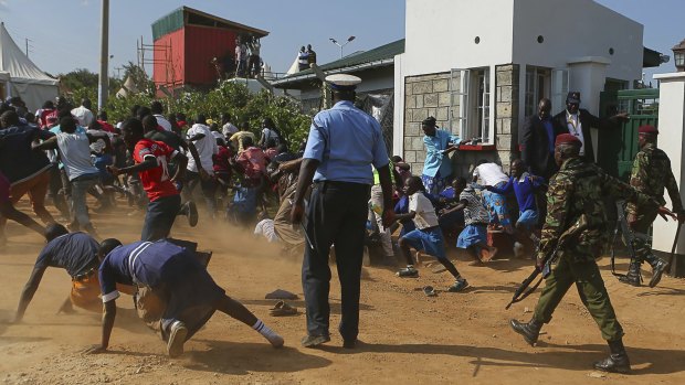 Police chase Kogelo residents away during Obama's visit on Monday.