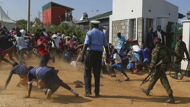 Police chase Kogelo residents away during Obama's visit on Monday.