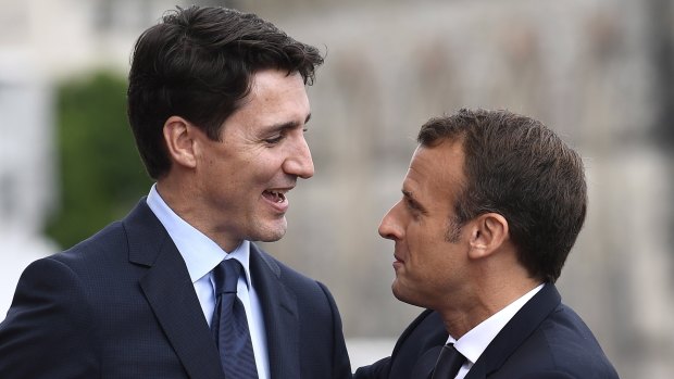 French President Emmanuel Macron, right, and Canadian Prime Minister Justin Trudeau embrace after Macron's arrival on Parliament Hill in Ottawa, Ontario.