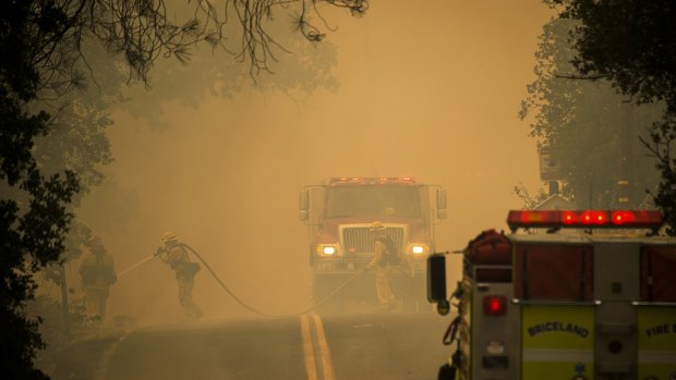 Firefighters work to contain a wildfire in Spring Valley, California on Sunday. 